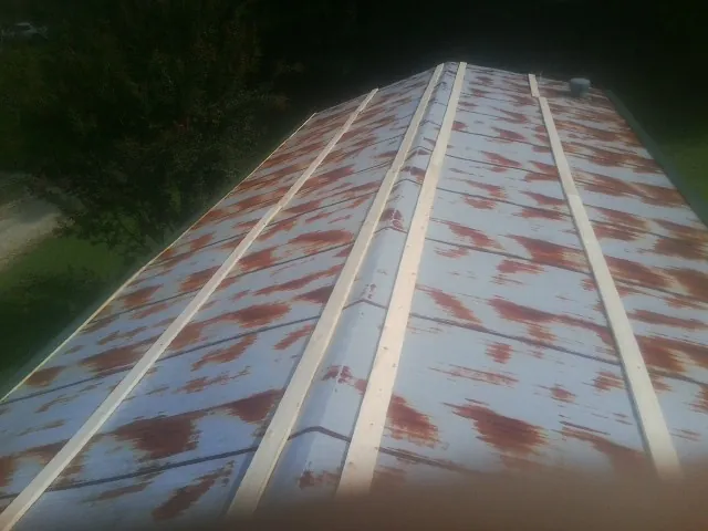 Rusted metal roof panels with new wood purlins before replacement — Storm Damage Roof Repair in Ariel by Roofing Brothers