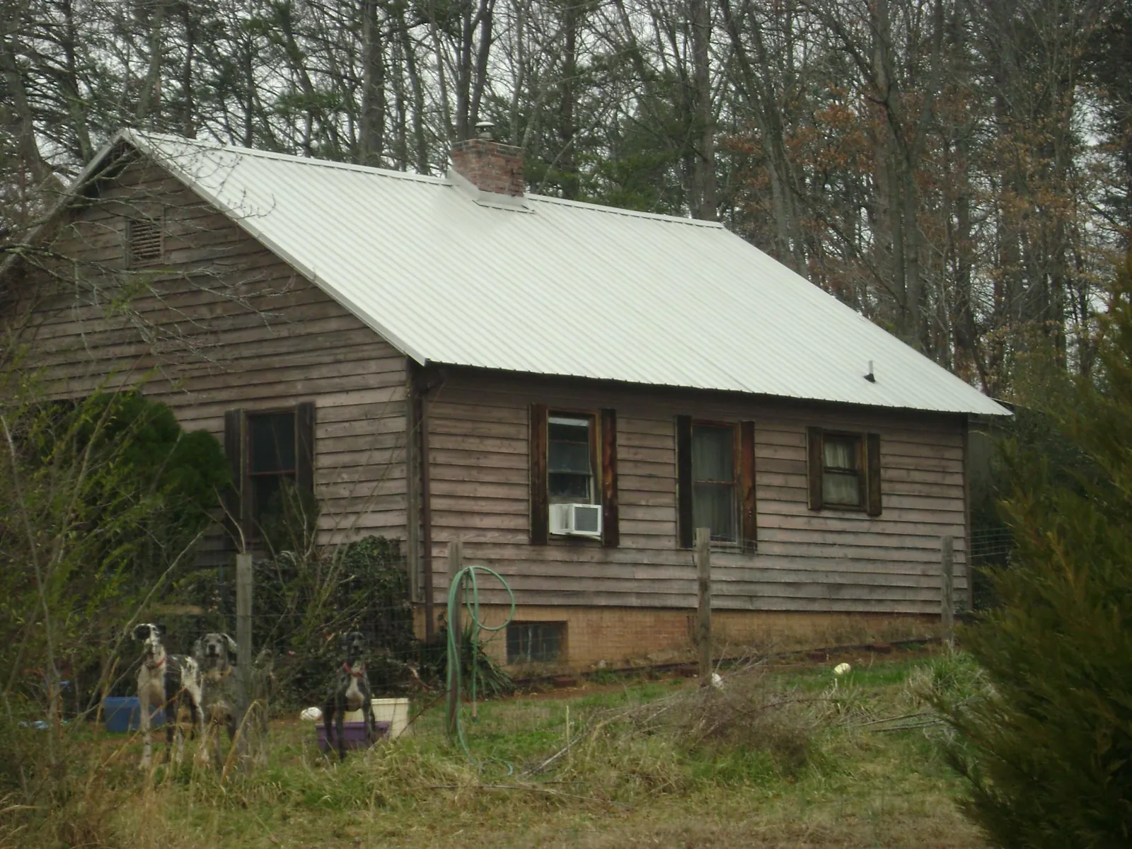 White metal roof on an old wood sided farmhouse, from a Metal Roof Installation job in Ariel